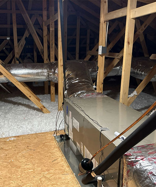 Professional HVAC ductwork installation in a residential attic