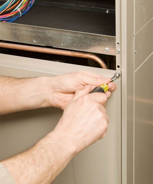 HVAC technician performing routine maintenance on a residential system